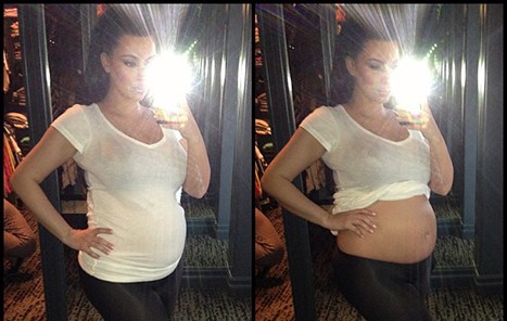 Kim Kardashian Rolls Up Shirt to Show Bare Baby Bump in New Picture