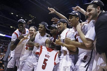 Louisville players celebrate following their 85-63 win over Duke in the Midwest Regional final in the NCAA college basketball tournament, Sunday, March 31, 2013, in Indianapolis. (AP Photo/Michael Conroy)