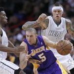 Miami Heat's Norris Cole (L) defends against Los Angeles Lakers' Steve Blake (C) as Heat teammate Chris Andersen (R) looks on in the first half of their NBA basketball game in Miami, Florida February 10, 2013. REUTERS/Andrew Innerarity