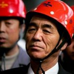 North Korea's Premier Pak Pong-ju (C) wears a hard hat as he visits the Anshan Steel factory in northeastern China March 26, 2005. REUTERS/Reinhard Krause