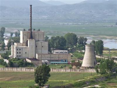 A North Korean nuclear plant is seen before demolishing a cooling tower (R) in Yongbyon, in this photo taken June 27, 2008 and released by Kyodo. REUTERS/Kyodo