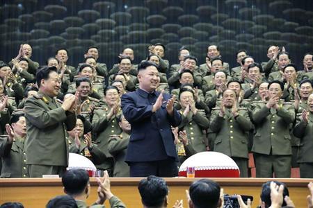Military officials applaud together with North Korean leader Kim Jong-un, during the Unhasu concert in Pyongyang, in this picture released by North Korea's KCNA news agency April 16, 2013. REUTERS/KCNA
