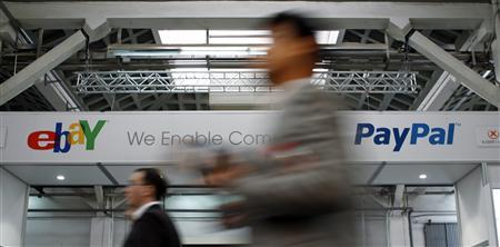 Visitors walk past an Ebay and PayPal banner at the Mobile World Congress in Barcelona February 28, 2012. REUTERS/Albert Gea