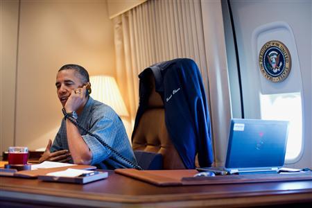 U.S. President Barack Obama talks on the phone with NASA's Curiosity Mars rover team aboard Air Force One during a flight to Offutt Air Force Base in Nebraska, in this handout photograph taken on August 13, 2012 and obtained on September 11, 2012 REUTERS/Official White House Photo by Pete Souza/handout