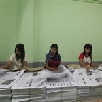 Workers arrange the pages of The Voice Daily newspaper at a press machine house in Yangon April 1, 2013. REUTERS/Soe Zeya Tun