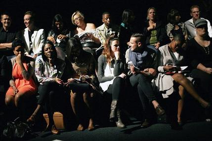 In this photograph taken Thursday April 11, 2013, South Africans wait for the start of a fashion show in Johannesburg.This month, South Africa opened a conversation _ not the first _ over the extent to which the shadow of apartheid drives today's social ills as society fights to overturn entrenched imbalances in services and opportunities. The fresh discussion began with reported comments by Trevor Manuel, national planning minister, that South African officials should assume full responsibility and resist the temptation to continually blame apartheid for missteps.(AP Photo/Jerome Delay)