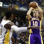 Los Angeles Lakers guard Steve Nash (10) of Canada shoots the basketball over Indiana Pacers center Ian Mahinmi of France during the first half of an NBA basketball game in Indianapolis, Indiana March 15, 2013. REUTERS/Brent Smith