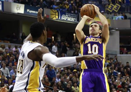 Los Angeles Lakers guard Steve Nash (10) of Canada shoots the basketball over Indiana Pacers center Ian Mahinmi of France during the first half of an NBA basketball game in Indianapolis, Indiana March 15, 2013. REUTERS/Brent Smith
