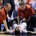Trainers check on Louisville guard Kevin Ware (5) after Ware injured his lower right leg during the first half of the Midwest Regional final against Duke in the NCAA college basketball tournament, Sunday, March 31, 2013, in Indianapolis. Ware left the court on a stretcher. (AP Photo/Michael Conroy)