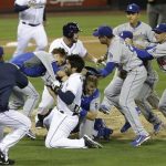 San Diego Padres' Carlos Quentin and teammates battle the Los Angeles Dodgers after Quentin was hit by a pitch thrown by Dodgers pitcher Zack Greinke in the sixth inning of baseball game in San Diego, Thursday, April 11, 2013. (AP Photo/Lenny Ignelzi)