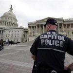 A law enforcement officer stands post at the U.S. Capitol, Monday, April 15, 2013 in Washington. Authorities say the blasts during the Boston Marathon killed two people and injured at least 73,(AP Photo/Alex Brandon)