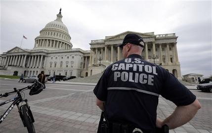 A law enforcement officer stands post at the U.S. Capitol, Monday, April 15, 2013 in Washington. Authorities say the blasts during the Boston Marathon killed two people and injured at least 73,(AP Photo/Alex Brandon)