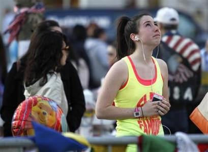 A woman looks up as she visits a memorial for the victims of the Boston Marathon bombings on Boylston Street in Boston, Massachusetts April 24, 2013. REUTERS/Jessica Rinaldi