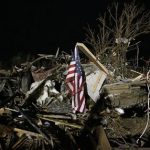 A flag flies in the debris of a mobile home after a tornado struck a mobile home park near Dale, Okla., Sunday, May 19, 2013. (AP Photo Sue Ogrocki)