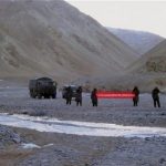 FILE - In this Sunday, May 5, 2013 photo, Chinese troops hold a banner which reads: "You've crossed the border, please go back," in Ladakh, India. While the recent troop standoff in a remote Himalayan desert spotlights a long-running border dispute between China and India, the two emerging giants are engaged in a rivalry for global influence that spreads much farther afield. (AP Photo/File) INDIA OUT