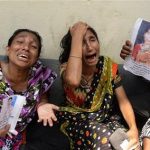 Relatives of victims from the garment factory building collapse grieve at a morgue on Wednesday May 1, 2013 in Dhaka, Bangladesh where a building housing garment factories that collapsed last week in the country's worst industrial disaster, left at least 402 people dead and injured 2,500. (AP Photo/Ismail Ferdous)