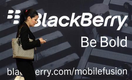 A woman uses her mobile phone at the Blackberry World Event in Orlando May 1, 2012. REUTERS/David Manning