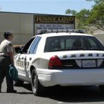 FILE - In this April 29, 2013 file photo, Calaveras County Sheriff's deputies and volunteers stand watch at Jenny Lind Elementary School, after the murder of one it's students over the weekend, in Valley Springs, Calif. Authorities on Saturday, May 11, 2013 arrested the 12-year-old brother of an 8-year-old girl who was mysteriously stabbed at her home in a quiet Northern California community last month. (AP Photo/Rich Pedroncelli, File)