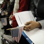 Candidates hold U.S. flags during a naturalization ceremony to become new U.S. Citizens at Convention Center in Los Angeles, California February 27, 2013. REUTERS/Mario Anzuoni