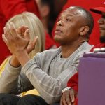 Recording artist Dr. Dre (C) attends the NBA basketball game between the Los Angeles Lakers and the Dallas Mavericks in Los Angeles April 2, 2013. REUTERS/Danny Moloshok