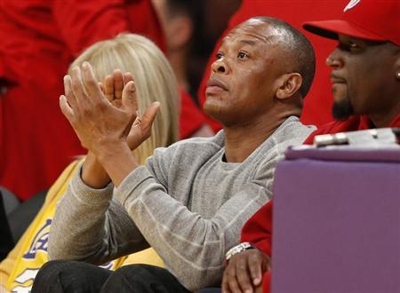 Recording artist Dr. Dre (C) attends the NBA basketball game between the Los Angeles Lakers and the Dallas Mavericks in Los Angeles April 2, 2013. REUTERS/Danny Moloshok