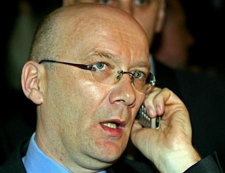 Bosnian Croat war time leader Jadranko Prlic, who is also a Croatian citizen, talks on a phone before departing for [The Hague] from Zagreb airport April 5, 2004.