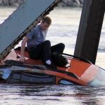 In this photo provided by Francisco Rodriguez, Bryce Kenning sits atop his car that fell into the Skagit River after the collapse of the Interstate 5 bridge there minutes earlier Thursday, May 23, 2013, in Mount Vernon, Wash. (AP Photo/Francisco Rodriguez)