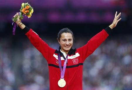 Gold medallist Turkey's Asli Cakir Alptekin smiles during the women's 1500 victory ceremony at the London 2012 Olympic Games at the Olympic Stadium August 11, 2012. REUTERS/Eddie Keogh