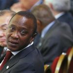 Kenya's President Uhuru Kenyatta turns to speak to a member of his delegation at the Somalia conference in London May 7, 2013. REUTERS/Andrew Winning