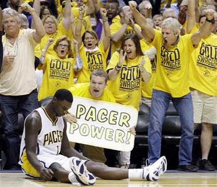 Indiana Pacers fans react after Lance Stephenson, sitting, made a shot against the Miami Heat as time expired in the third quarter of Game 4 of the NBA basketball Eastern Conference finals, Tuesday, May 28, 2013, in Indianapolis. (AP Photo/Michael Conroy)
