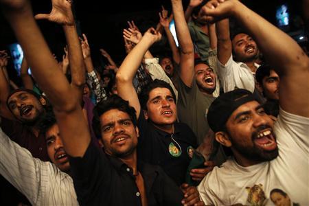 Supporters of the Pakistan Muslim League - Nawaz (PML-N) celebrate in front of a party office as results of the general election come in, in Lahore May 11, 2013. Former Prime Minister Nawaz Sharif said on Saturday his PML-N party was the clear winner in Pakistan's general election and that he hoped for a majority to avoid a coalition. REUTERS/Damir Sagolj