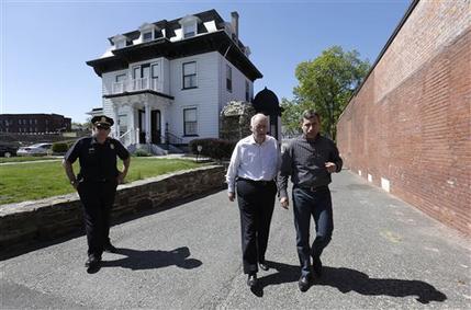 Ruslan Tsarni, right, uncle of killed Boston Marathon bombing suspect Tamerlan Tsarnaev, approaches members of the media, not shown, in front of the Graham, Putnam, and Mahoney Funeral Parlors, in Worcester, Mass., as funeral director and owner Peter Stefan, center, walks with him Sunday, May 5, 2013. Stefan has pleaded for government officials to use their influence to convince a cemetery to bury Tsarnaev, but so far no state or federal authorities have stepped forward. (AP Photo/Steven Senne)