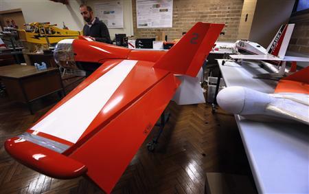 Salah Sukkarieh, professor of Robotics and Intelligent Systems at the University of Sydney, Australian Centre for Field Robotics, stands next to one of his robotic aircraft in his laboratory in Sydney April 24, 2013. REUTERS/David Gray