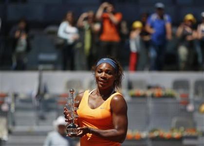 Serena Williams of the U.S. poses with the Ion Tiriac's trophy after winning the Madrid Open final tennis match over Maria Sharapova of Russia in Madrid May 12, 2013. REUTERS/Susana Vera