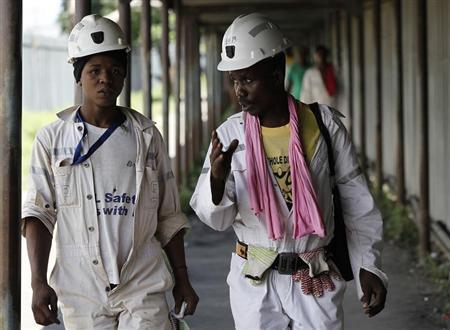 Miners walk at the end of their shift at the Anglo Platinum's Khuseleka shaft 1 mine in Rustenburg, northwest of Johannesburg, January 15, 2013. REUTERS/Siphiwe Sibeko