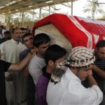 Men carry the coffin of a victim, killed in Friday's bomb attack, during a funeral in al-Rashidiya district of Baghdad, May 3, 2013. REUTERS/Thaier al-Sudani