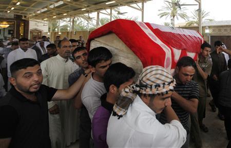 Men carry the coffin of a victim, killed in Friday's bomb attack, during a funeral in al-Rashidiya district of Baghdad, May 3, 2013. REUTERS/Thaier al-Sudani