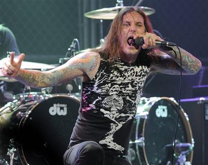 FILE - In this file photo taken Thursday, April 8, 2010, Tim Lambesis of As I Lay Dying performs at the second annual Revolver Golden Gods Awards in Los Angeles. Authorities say the singer of Grammy-nominated heavy metal band As I Lay Dying has been arrested Tuesday May 7, 2013 in Southern California after trying to hire an undercover detective to kill his estranged wife. The San Diego County Sheriffs Department says in a statement that 32-year-old Tim Lambesis was arrested Tuesday in Oceanside. (AP Photo/Chris Pizzello, File)