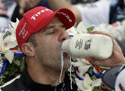 Tony Kanaan, of Brazil, celebrates by drinking the winners milk after winning the Indianapolis 500 auto race at the Indianapolis Motor Speedway in Indianapolis, Sunday, May 26, 2013. (AP Photo/Darron Cummings)