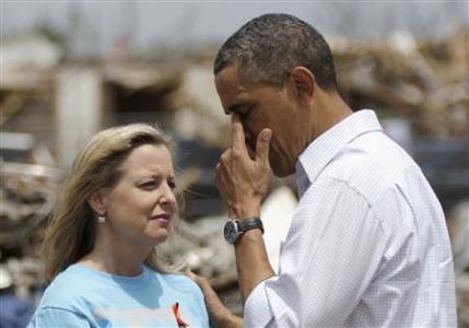 U.S. President Barack Obama wipes away tears after hugging Plaza Tower Elementary School Principal Amy Simpson in Moore, Oklahoma, May 26, 2013. REUTERS/Jonathan Ernst