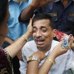 Colleagues comfort a company official as he cries after a fire at a factory belonging to Tung Hai Group, a large garment exporter, in Dhaka May 9, 2013. REUTERS/Andrew Biraj