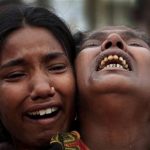 A woman is comforted as she grieves after identifying the body of her daughter, a victim of the garment factory collapse, Sunday, May 5, 2013 in Savar, near Dhaka, Bangladesh. The death toll from the collapse of a shoddily built garment-factory building in Bangladesh continued its horrifying climb, reaching 580 on Sunday with little sign of what the final number will be. The disaster is likely the worst garment-factory accident ever, and there have been few industrial accidents of any kind with a higher death toll. (AP Photo/Wong Maye-E)