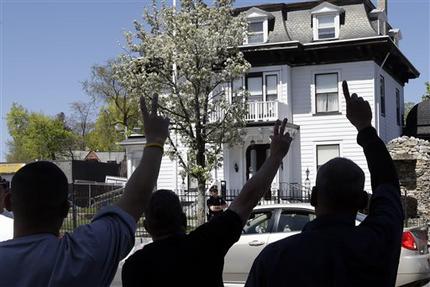 Protesters gesture outside the Graham, Putnam, and Mahoney Funeral Parlors in Worcester, Mass., Monday, May 6, 2013, where the body of killed Boston Marathon bombing suspect Tamerlan Tsarnaev is being prepared for burial. Funeral director Peter Stefan has pleaded for government officials to use their influence to convince a cemetery to bury Tsarnaev, but so far no state or federal authorities have stepped forward. (AP Photo/Elise Amendola)