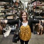 This photo taken May 2, 2013, shows Sarah Davis, co-owner of Fashionphile.com, posing with her bags in a company warehouse in the Carlsbad, Calif. The Internet company sells rare, vintage, and discontinued previous owned bags and is facing the complicated task of dealing with new state regulations on Internet sale taxes. (AP photo/Lenny Ignelzi)