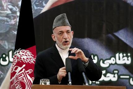 Afghan President Hamid Karzai speaks at a press conference during a ceremony at a military academy on the outskirts of Kabul, Afghanistan, Tuesday, June 18, 2013. Afghan forces have taken over the lead from the U.S.-led NATO coalition for security nationwide, Karzai announced in the significant milestone in the 12-year war. (AP Photo/Rahmat Gul)
