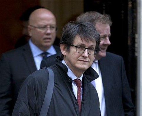 FILE - This is a Tuesday, Dec. 4, 2012 file photo of  the editor of the  Guardian newspaper Alan Rusbridger  as he leaves Downing street  after a meeting of fellow newspaper editors  and the British Prime Minister David Cameron following the release of the Leveson media inquiry in London.  The Guardian newspaper, which started publishing in the English city of Manchester in 1821 and is now based in London, has in the last two days established a major presence in Washington by uncovering the vast scope of secret surveillance operations carried out by U.S. officials. The revelations have put President Barack Obama and his national security team on the defensive with reports of government snooping on a comprehensive scale. Its coverage expanded to Britain on Friday June 7, 2013 with an exclusive report that Britains electronic surveillance agency has had access to data collected by the Americans.  (AP Photo/Alastair Grant, File)