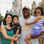 This June 2013 photo provided by Disney PhotoPass Service shows Creed Anthony of Indianapolis with his daughter Sophie, 5, son Isaac, 2, and wife Amal, on a visit to Disney Worlds Magic Kingdom in Lake Buena Vista, Fla. Anthony is an example of a new generation of hands-on dads who dont just change the occasional diaper but who view parenting as a partnership, as he put it, by being as involved in childrearing as moms. (AP Photo/Disney PhotoPass Service)