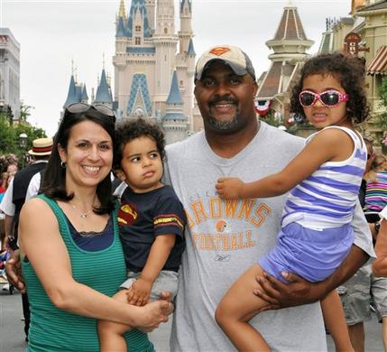 This June 2013 photo provided by Disney PhotoPass Service shows Creed Anthony of Indianapolis with his daughter Sophie, 5, son Isaac, 2, and wife Amal, on a visit to Disney Worlds Magic Kingdom in Lake Buena Vista, Fla. Anthony is an example of a new generation of hands-on dads who dont just change the occasional diaper but who view parenting as a partnership, as he put it,  by being as involved in childrearing as moms. (AP Photo/Disney PhotoPass Service)