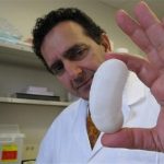 Dr. Anthony Atala holds the "scaffolding" for a human kidney created by a 3-D printer in a laboratory at Wake Forest University in Winston-Salem, N.C., on Wednesday, May 8, 2013. The university is experimenting with various ways to create replacement organs for human implantation, from altering animal parts to building them from scratch with a patient's own cells. (AP Photo/Allen Breed)