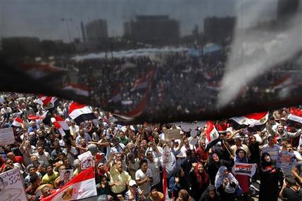 Opponents of Egypt's Islamist President Mohammed Morsi wane national flags as they demonstrate in Tahrir Square in Cairo, Egypt, Friday, June 28, 2013. Thousands of supporters of Egypt's embattled president are rallying in the nation's capital in a show of support ahead of what are expected to be massive opposition-led protests on June 30 to demand Mohammed Morsi's ouster.(AP Photo/Amr Nabil)